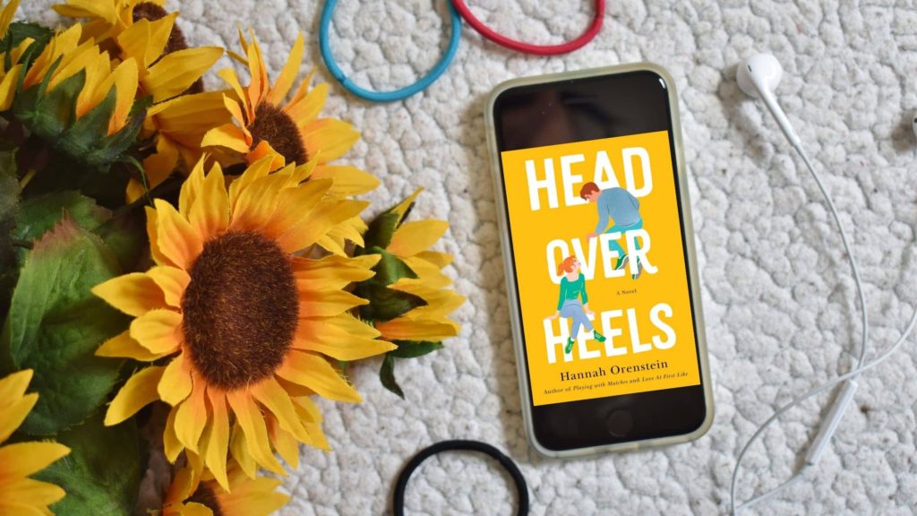 Head Over Heels on iPhone with headphones, sunflowers, and hair ties