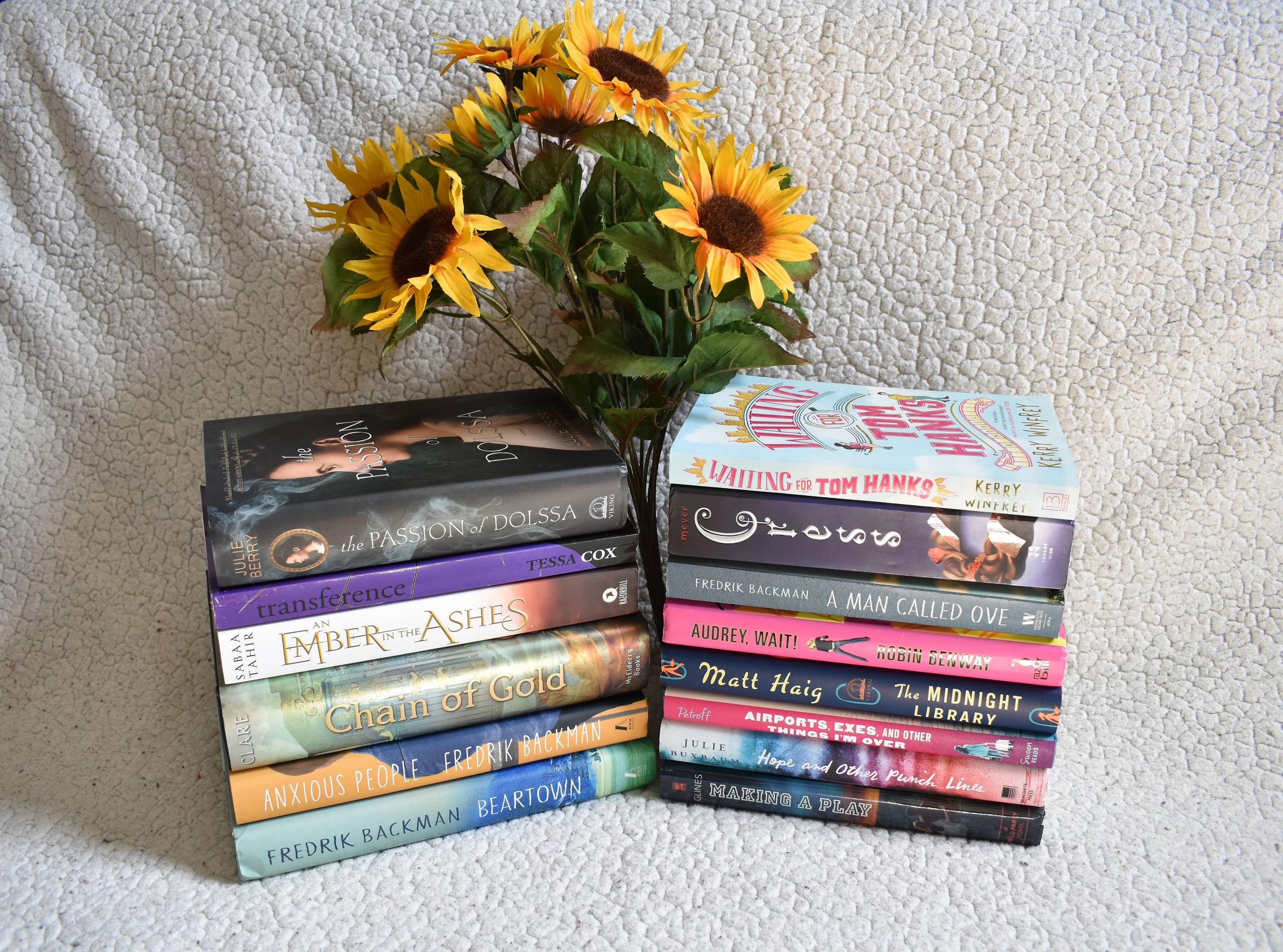 two stacks of books and sunflowers